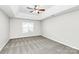 Large bedroom with ceiling fan and carpet at 8708 Berrybrook Ln, Charlotte, NC 28269