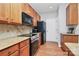 Modern kitchen with wood cabinets and stainless steel appliances at 1001 Serel Dr, Matthews, NC 28104