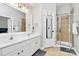 Bathroom with double vanity, large mirror, and shower stall at 1001 Serel Dr, Matthews, NC 28104