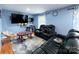 Relaxing living room with reclining sofas and a large TV at 2209 Laura Dr, Charlotte, NC 28212
