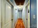 Light blue hallway with wood floors and doors to other rooms at 2209 Laura Dr, Charlotte, NC 28212