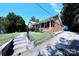 Brick ranch home with a side yard and steps leading to the entrance at 2209 Laura Dr, Charlotte, NC 28212
