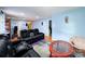 Spacious living room with reclining sofas, hardwood floors, and a view of the hallway at 2209 Laura Dr, Charlotte, NC 28212