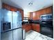 Kitchen with stainless steel appliances and wood cabinets at 2209 Laura Dr, Charlotte, NC 28212