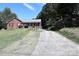 Brick ranch home with a long driveway and mature trees at 2209 Laura Dr, Charlotte, NC 28212
