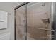 Updated shower with glass enclosure and neutral tile at 4721 Morehead Rd # 409, Concord, NC 28027