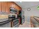 Updated kitchen with stainless steel appliances and wood cabinets at 4721 Morehead Rd # 409, Concord, NC 28027