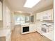 Kitchen boasts white cabinets, tile floors, and modern appliances at 11334 Longhedge Ln, Charlotte, NC 28273