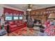 Living room with a brick fireplace, built in shelving, and red leather couch at 225 Frye Hts, Taylorsville, NC 28681