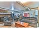 Finished basement with a wood burning stove, gray recliner, and a sitting area at 225 Frye Hts, Taylorsville, NC 28681