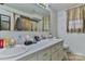 Bathroom with double vanity, large mirror, and beige tile floors at 225 Frye Hts, Taylorsville, NC 28681