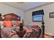 Bedroom with a dark wood bed frame and orange and purple pillows at 225 Frye Hts, Taylorsville, NC 28681