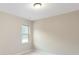 Spacious bedroom with neutral walls and carpet, featuring a large window and double doors at 213 E Warfield Dr, Mooresville, NC 28115