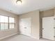 Well-lit bedroom with neutral walls, carpet, double doors, and a window at 213 E Warfield Dr, Mooresville, NC 28115