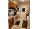 Galley kitchen with wood cabinets and appliances at 5012 Sardis Rd # D, Charlotte, NC 28270