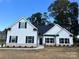 White farmhouse exterior with black accents and stonework at 7809 Medlin Rd, Monroe, NC 28112