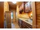 Bright laundry room with washer, dryer, custom cabinets, and wood flooring at 1235 Bob Falls Dr, Shelby, NC 28150