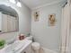 Clean bathroom with single vanity, toilet, and shower/tub combo at 540 Harbor Rd, Norwood, NC 28128