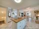 Open kitchen with island, white cabinets, and view into living area at 540 Harbor Rd, Norwood, NC 28128
