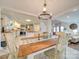 Farmhouse-style dining room with a wooden table and chandelier at 540 Harbor Rd, Norwood, NC 28128