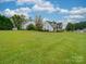 Two-story house with large yard, a detached shed, and a spacious front porch at 540 Harbor Rd, Norwood, NC 28128