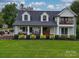 Two story home with white exterior, dark roof, and a large front porch at 540 Harbor Rd, Norwood, NC 28128