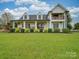 Two-story white farmhouse with a large front porch at 540 Harbor Rd, Norwood, NC 28128