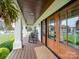 Relaxing front porch with rocking chairs and double doors at 540 Harbor Rd, Norwood, NC 28128
