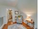 Upstairs hallway with cozy sitting area and hardwood floors at 540 Harbor Rd, Norwood, NC 28128