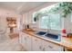 Kitchen features a double sink, wood countertops, and white cabinets at 540 Harbor Rd, Norwood, NC 28128