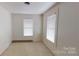 Small bedroom with two windows and carpet at 309 Elm St, Marshville, NC 28103