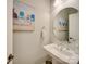 Charming powder room with a pedestal sink and decorative mirror at 82220 Standing Oak Dr, Charlotte, NC 28278