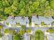 Aerial perspective of townhouses nestled amongst lush greenery at 10320 Berkeley Pond Dr, Charlotte, NC 28277