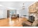 Living room with hardwood floors, stone fireplace, and comfortable seating at 10320 Berkeley Pond Dr, Charlotte, NC 28277