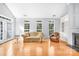 Living room boasting hardwood floors, fireplace and large windows at 10320 Berkeley Pond Dr, Charlotte, NC 28277