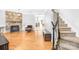 Living room with hardwood floors, stone fireplace, and view to kitchen at 10320 Berkeley Pond Dr, Charlotte, NC 28277