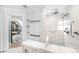 Modern bathroom with marble shower, built-in shelves, and a view to bedroom at 10320 Berkeley Pond Dr, Charlotte, NC 28277