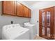 Laundry room with washer, dryer, and built-in cabinetry at 10320 Berkeley Pond Dr, Charlotte, NC 28277