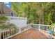 Elevated deck overlooking wooded backyard with white railing at 10320 Berkeley Pond Dr, Charlotte, NC 28277