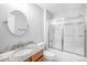 Clean bathroom with granite countertop, large mirror, and shower/tub combo at 10320 Berkeley Pond Dr, Charlotte, NC 28277
