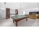 Finished basement with pool table, wet bar, and seating area at 10320 Berkeley Pond Dr, Charlotte, NC 28277