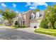 Townhome exterior with a driveway and landscaping at 10320 Berkeley Pond Dr, Charlotte, NC 28277