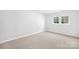 Simple bedroom with neutral walls and carpet flooring at 10320 Berkeley Pond Dr, Charlotte, NC 28277