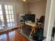 Bright home office features hardwood floors, French doors to balcony, and workspace with two monitors at 916 Mcalway Rd # D, Charlotte, NC 28211