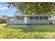 Gray house with red brick accents and a well-maintained lawn at 2409 Thornton Rd, Charlotte, NC 28208