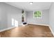 Spare bedroom with wood-look floors and neutral walls at 2409 Thornton Rd, Charlotte, NC 28208