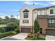 Brick front of charming townhome with a two-car garage and well-manicured landscaping at 4014 City Homes Pl, Charlotte, NC 28209