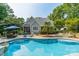 Relaxing kidney shaped pool with a stone patio and lush landscaping at 293 Bayberry Creek Cir, Mooresville, NC 28117