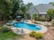 Inviting kidney-shaped pool with a patio and lounge area in backyard at 293 Bayberry Creek Cir, Mooresville, NC 28117