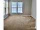 Bright living room with neutral walls and carpet at 7945 Mariners Pointe Cir, Denver, NC 28037